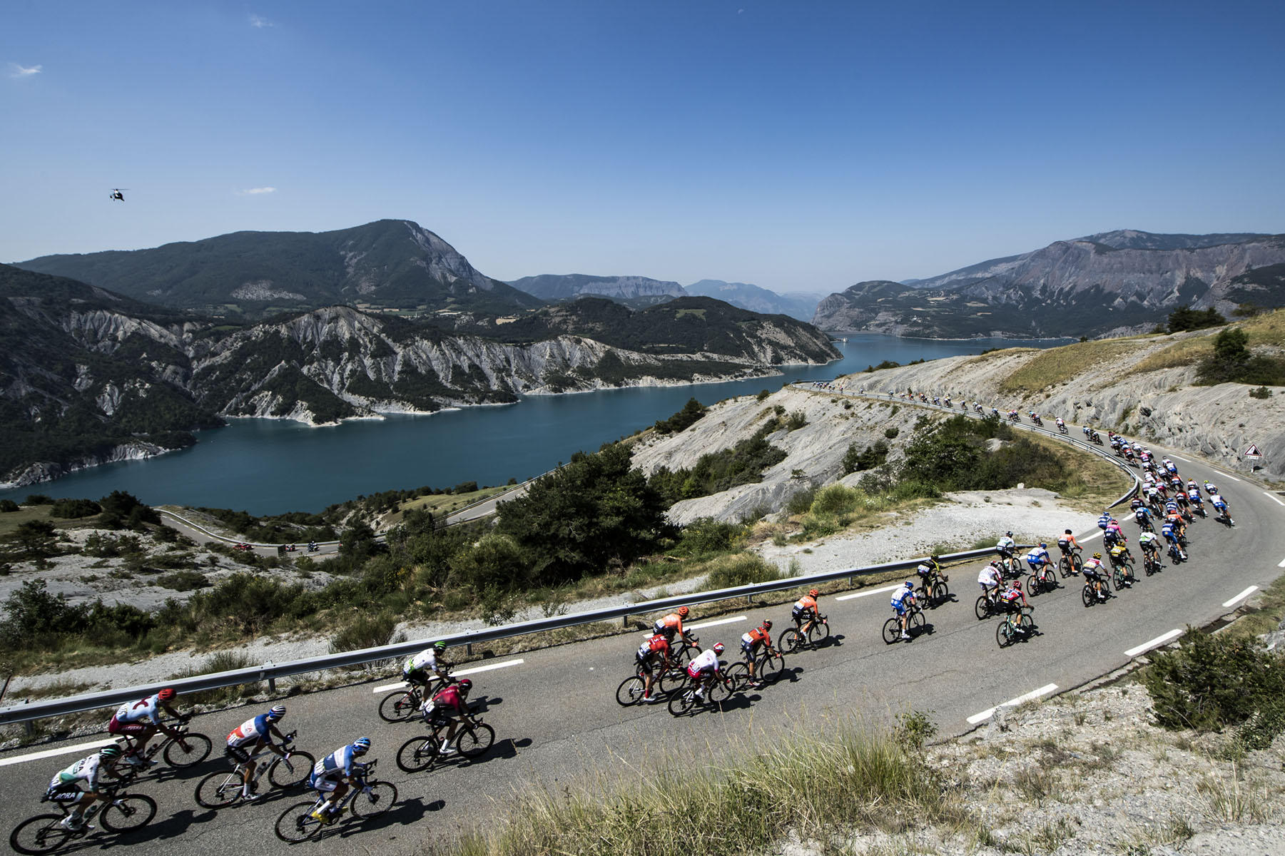 Tour de France 2019 - Stage Eighteen - The peloton descends towards Lac de Serre Poncon